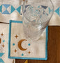Decorative table setting with gold cutlery, plates, and a patterned placemat.